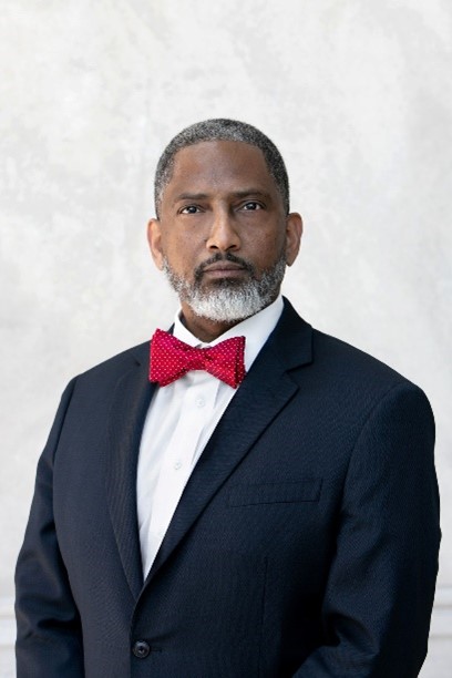 Professional portrait of an attorney in a suit and red bow tie
